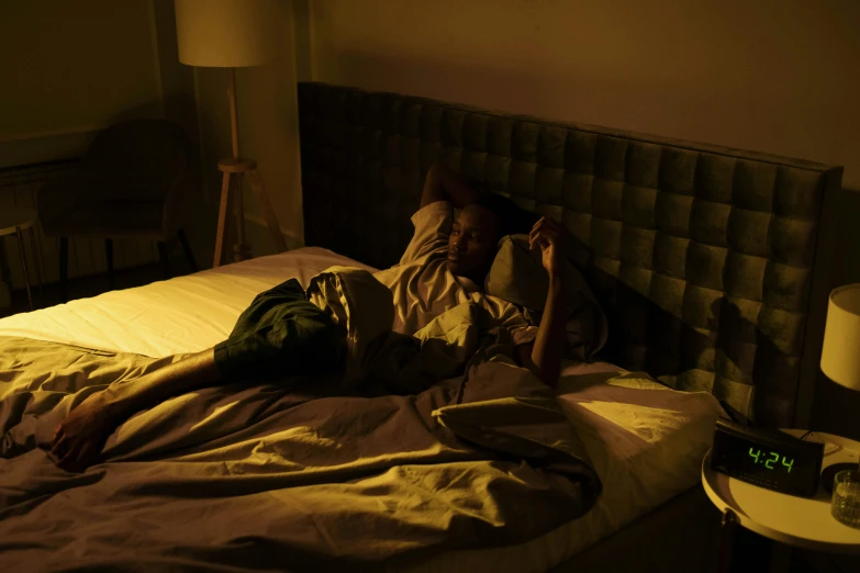 a man sleeping on a bed covered in blankets and a blanket