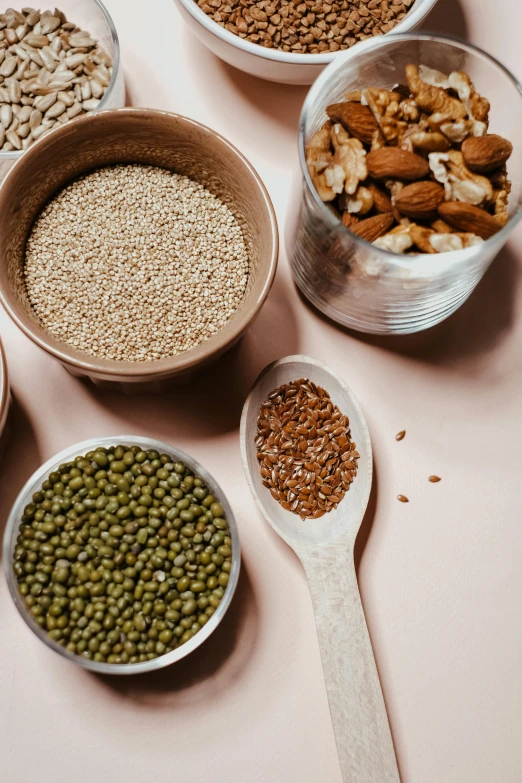 a table topped with bowls filled with different types of food, a still life, by Nicolette Macnamara, trending on pexels, mineral grains, spoon, green, detailed product image