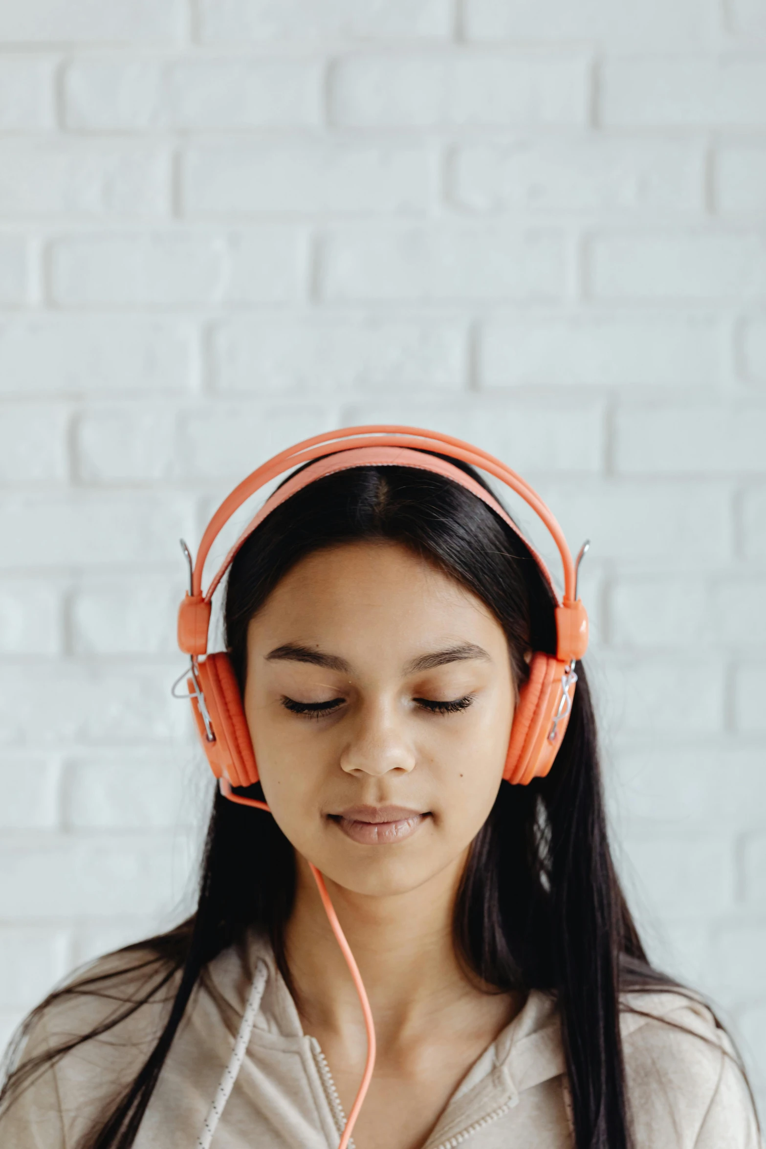 a woman listening to music with headphones, trending on pexels, renaissance, white and orange, student, on a pale background, programming