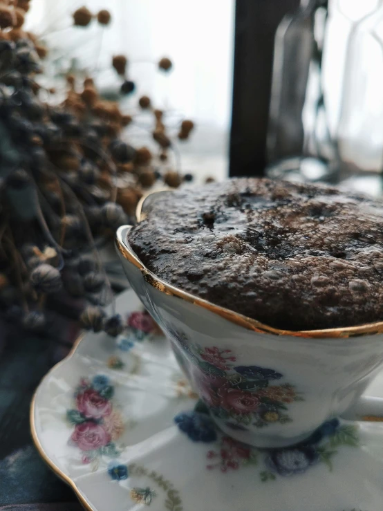 a close up of a cup of food on a saucer, next to a plant, covered with tar, 🎀 🧟 🍓 🧚, thumbnail