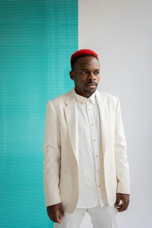 a man in a white suit and red hat, trending on unsplash, afrofuturism, receding hairline, teal suit, in front of white back drop, looking towards the camera