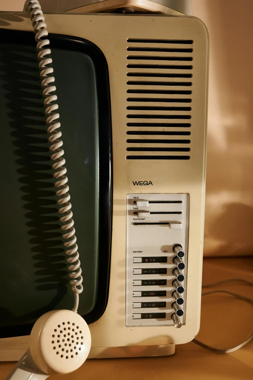 an old television sitting on top of a wooden table, an album cover, inspired by Elsa Bleda, unsplash, telephone wires, control panel, detail shot, hotel room