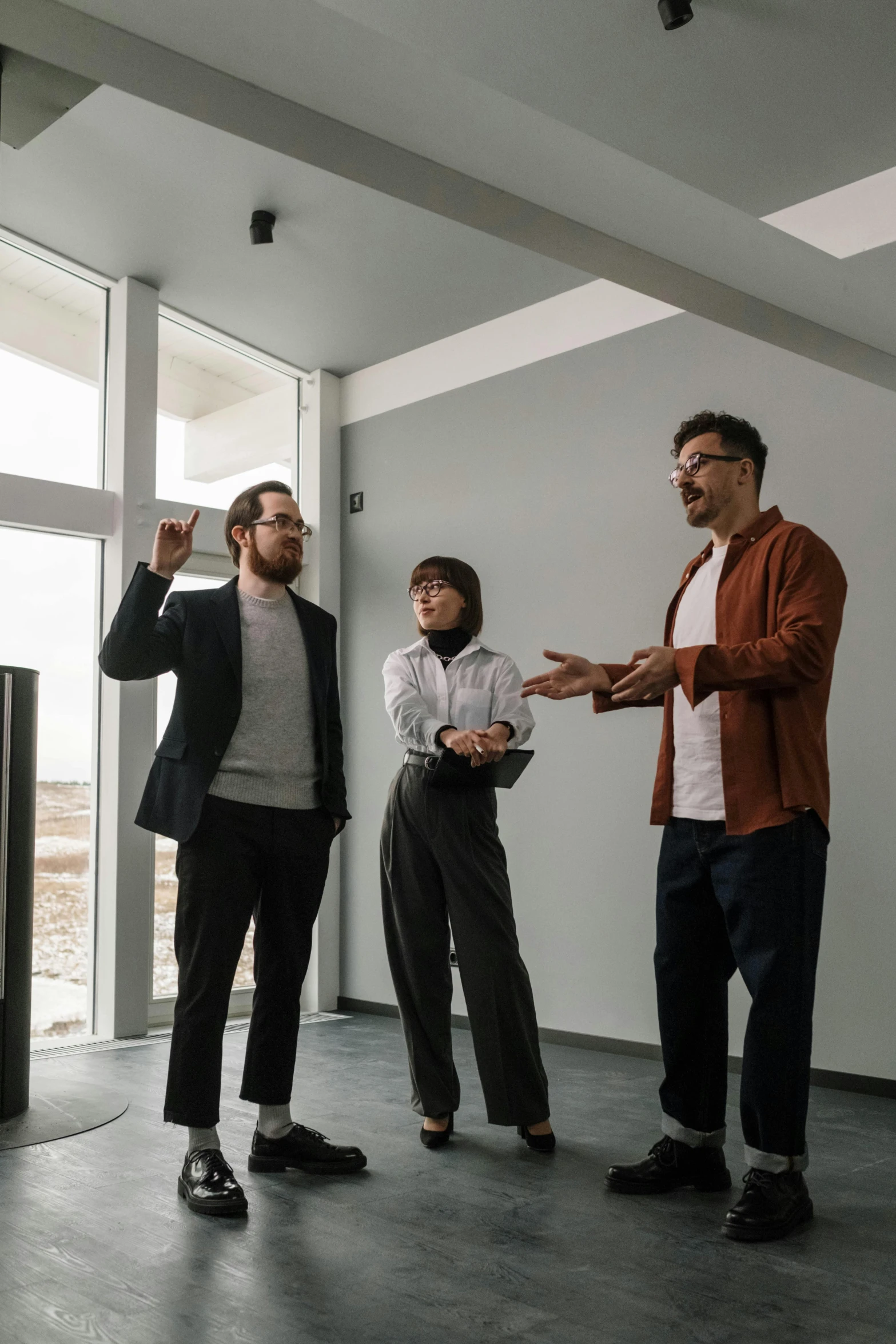 a group of men standing next to each other in a room, pexels contest winner, modernism, zillow interior, giving a speech, professional cooperate, tall ceilings