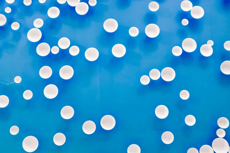 a bunch of white balloons floating in the air, inspired by Yayou Kusama, unsplash, interactive art, neon blue, panels, pool tubes, vibrant: 0.75