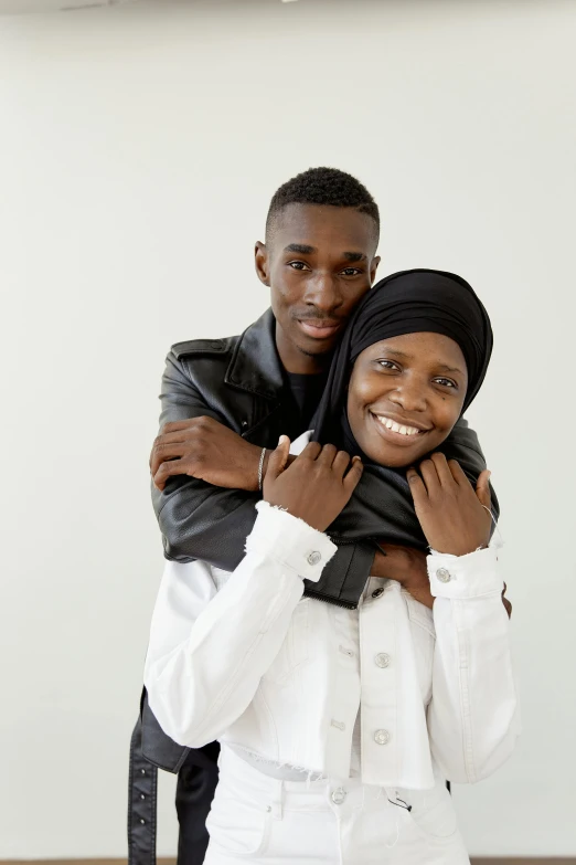 a man and a woman posing for a picture, by Matija Jama, hurufiyya, holding each other, covered, genderless, promotional image