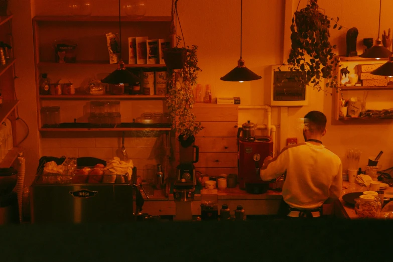 the man is cooking in his home kitchen