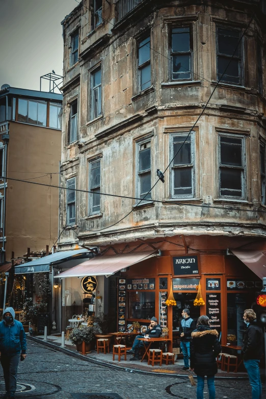 people walk around in front of a building