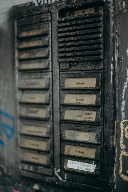 a close up of a wall with graffiti on it, an album cover, unsplash, lockers, vintage electronics, smokey burnt envelopes, labeled