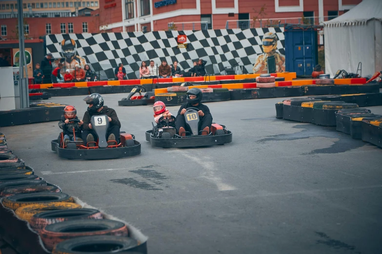 two men racing down the road on their motor powered bumper cars