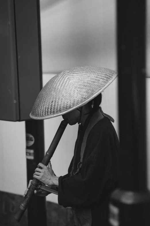 a woman with a straw hat carrying an umbrella
