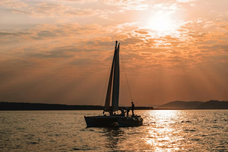a sailboat in the middle of a large body of water, in the sunset, on a boat, jeszika le vye, evening time