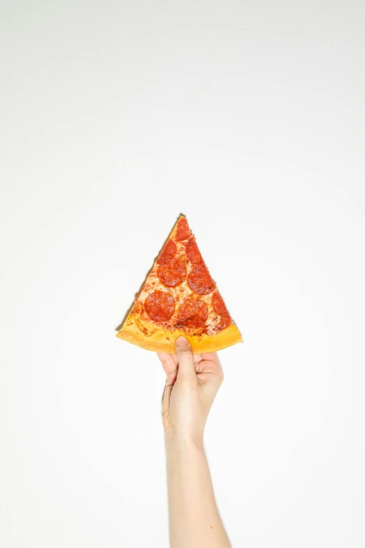 hand holding up a paper with slices of pizza on top