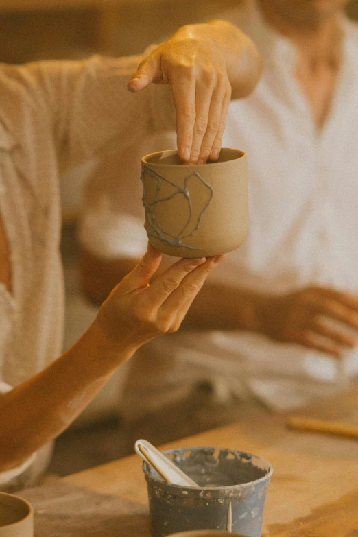 a couple of people that are sitting at a table, an ultrafine detailed painting, trending on unsplash, process art, wood cups, detailed clay model, intimately holding close, spa