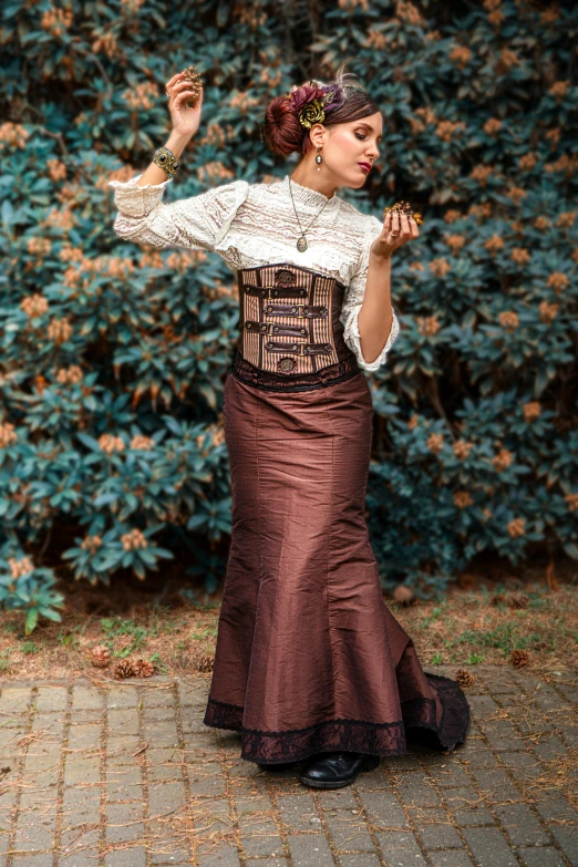 a woman wearing a corset standing in front of a bush, inspired by Rudolf von Alt, pexels contest winner, wearing a steampunk sari, long skirt, brown ) ), modest!