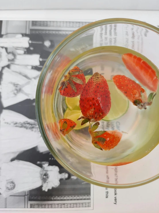 a glass of water with strawberries in it, inspired by Stanley Spencer, unsplash, photorealism, 😭 🤮 💕 🎀, slim aarons, tea, araki nobuyoshi