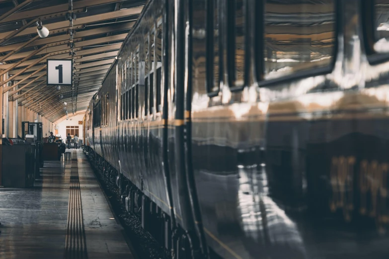 a train parked inside of a train station, by Emma Andijewska, pexels contest winner, grey, victoriana, zoomed in, 🚿🗝📝