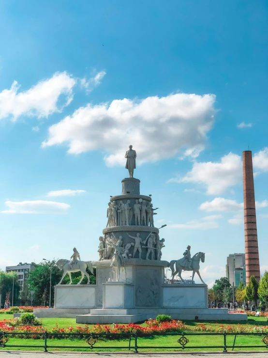 a statue sitting in the middle of a lush green park, a statue, inspired by Benito Quinquela Martín, 🚿🗝📝, neoclassical tower with dome, pilar, standing in a city center