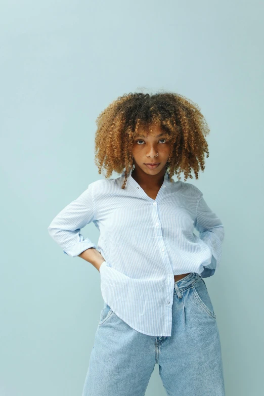 a black woman wearing blue jeans and white shirt