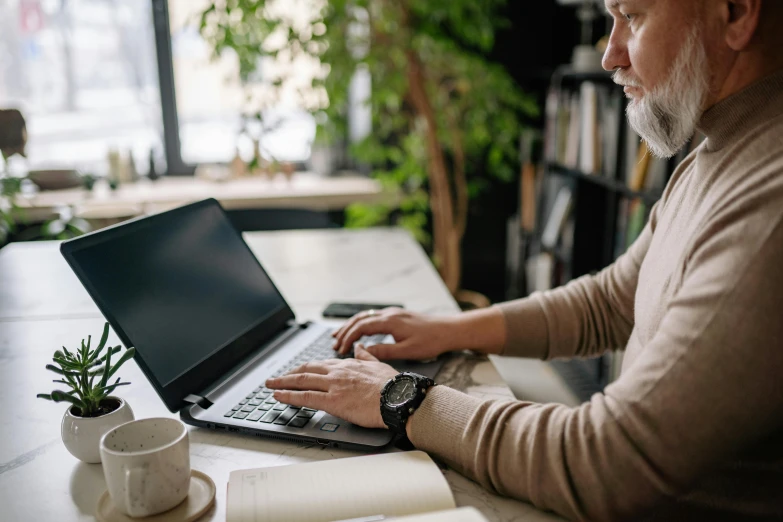 a man sitting at a table using a laptop computer, pexels contest winner, old gigachad with grey beard, fully functional, from waist up, avatar image