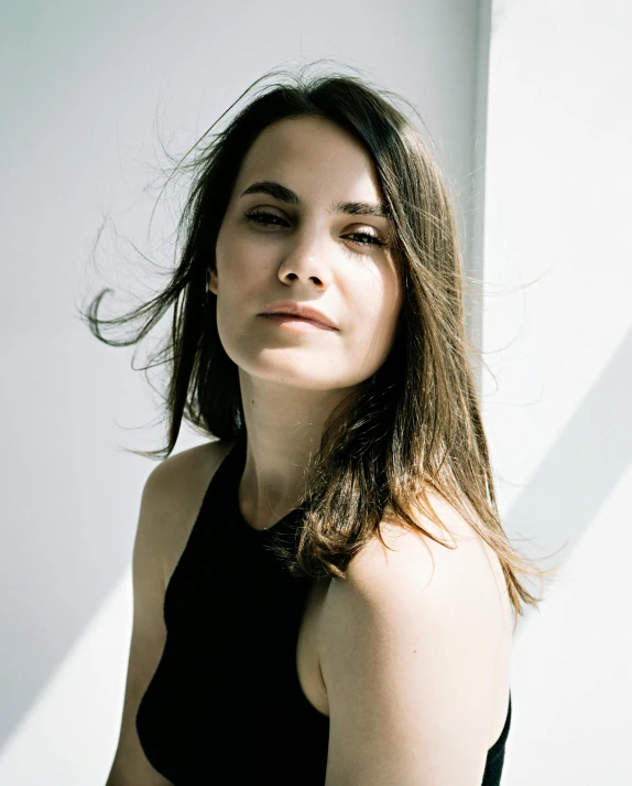 a woman in a black top posing for a picture, inspired by Anna Füssli, happening, looking away from camera, musician, natali portman, queer woman