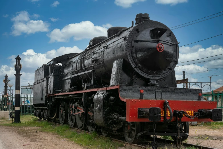 a black train sitting on top of a train track, well preserved, oversized enginee, 🚿🗝📝, istock