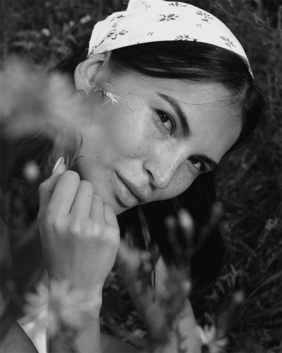 a black and white photo of a woman wearing a headband, a black and white photo, by Emma Andijewska, pexels contest winner, in the grass, emily ratajkowski, sparse freckles, miro petrov