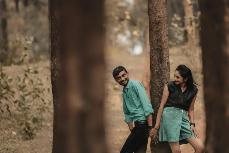 a man and a woman leaning against a tree, by Max Dauthendey, pexels contest winner, happening, playful pose, cinematic full shot, thumbnail, teaser