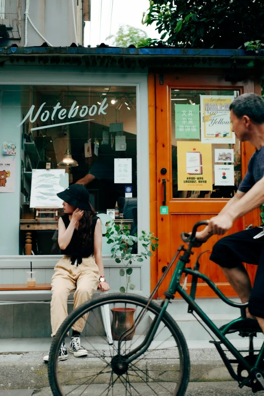 a person on a bicycle outside of a store