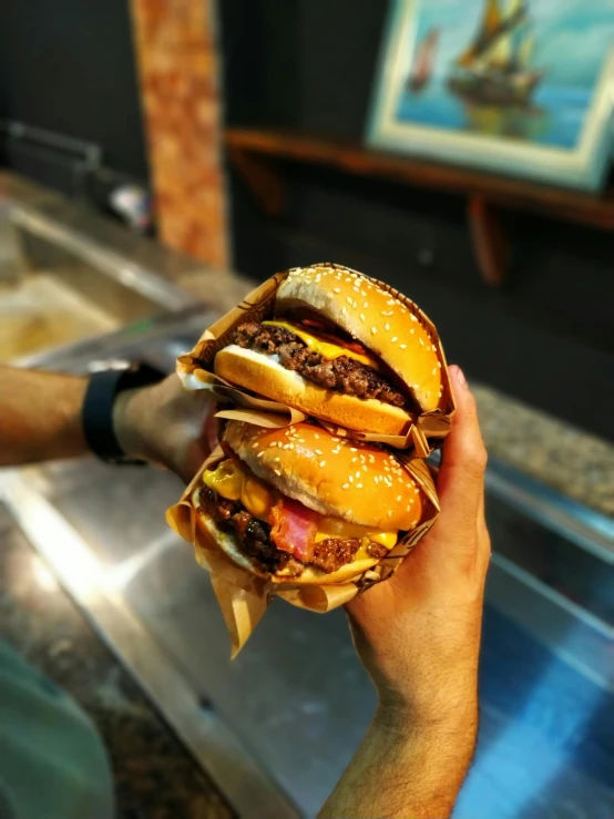 a close up of a person holding a hamburger, profile image