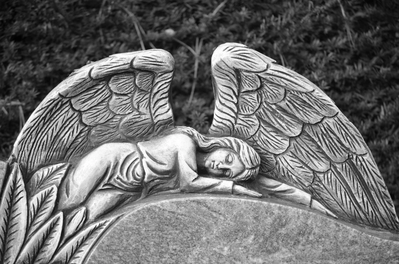 a black and white photo of an angel statue, inspired by Gustav Doré, art nouveau, laying down, gravestones, medium detail, good night