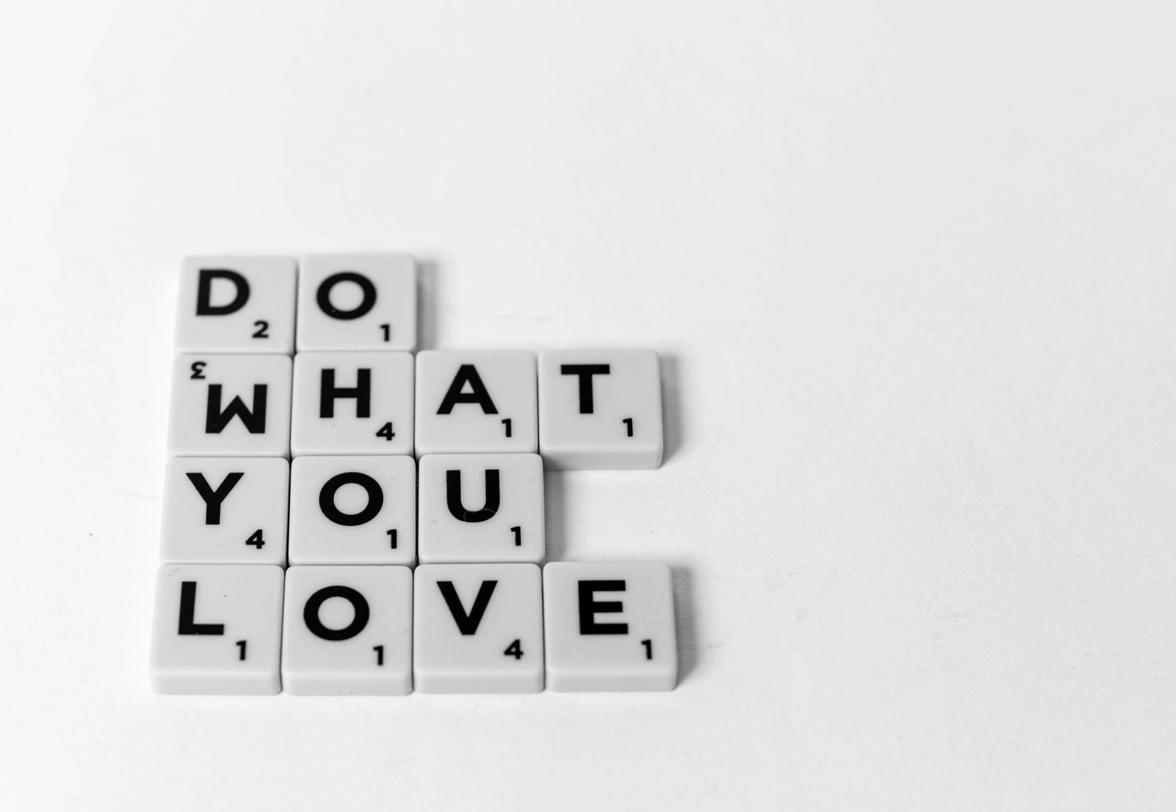 a white square tile crossword with words do what you love