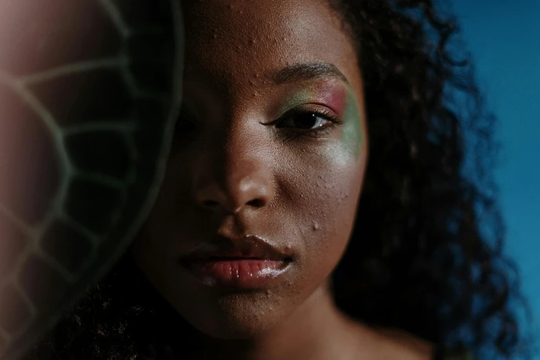 a close up of a woman's face with makeup, pexels contest winner, afrofuturism, rain lit, sza, greenish skin, shot on sony alpha dslr-a300