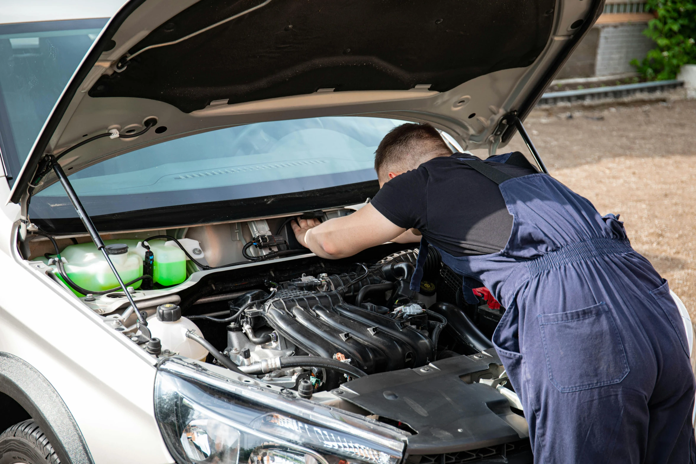 a man in overalls working on a car engine, a portrait, shutterstock, 15081959 21121991 01012000 4k, lachlan bailey, aftermarket parts, renault ultimo