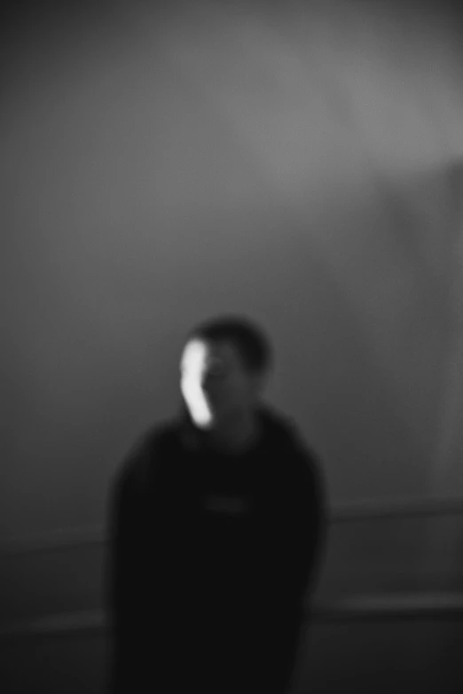 a black and white photo of a man in a dark room, inspired by Jan Rustem, blurry and glitchy, rex orange county, 16k resolution:0.6|people, photographed in film
