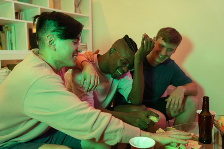 a group of people sitting on top of a couch, iridescent glowing chips, mix of ethnicities and genders, eating, two buddies sitting in a room