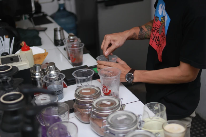 a man is making a smoothie in a blender, by Robbie Trevino, resin, jars, thumbnail, plating