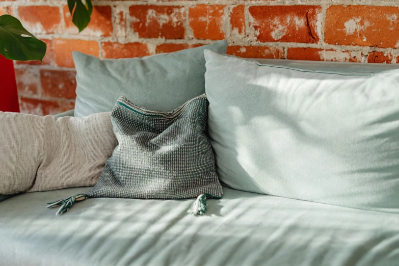 there are four pillows on the bed together