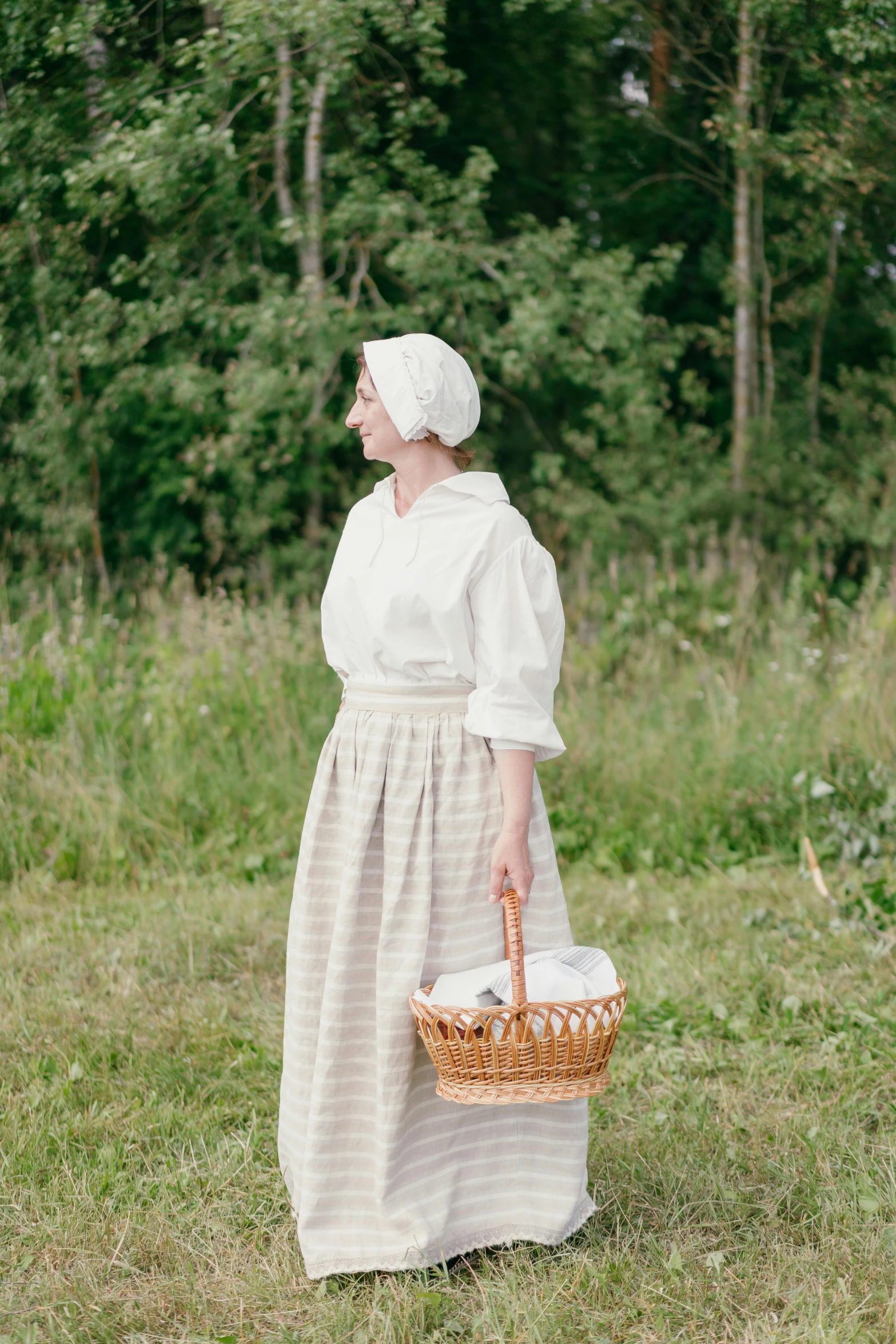 a woman standing in a field holding a basket, inspired by Elsa Beskow, unsplash, renaissance, production photo, portrait image, white, 1 8 5 0 s clothing