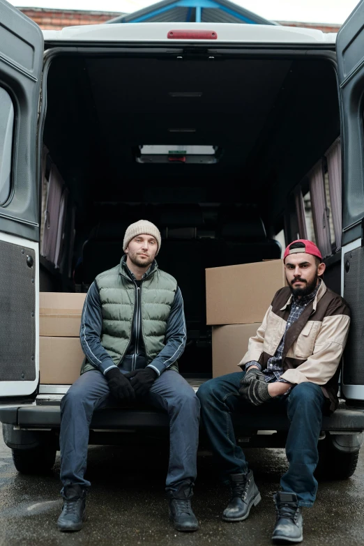 two men sitting in the back of a van, a portrait, pexels contest winner, renaissance, kilian eng and jake parker, cardboard, promotional image, hunters