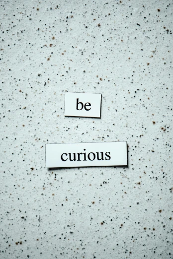 a picture of a sign that says be curious, unsplash, fluxus, magnetic, profile image, concrete poetry, precious gems
