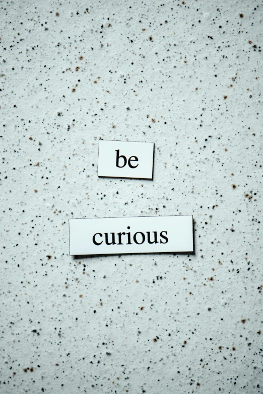 a picture of a sign that says be curious, unsplash, fluxus, magnetic, profile image, concrete poetry, precious gems