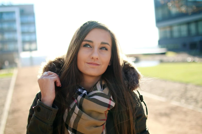 a woman in a parka is posing for a picture, a portrait, by Julia Pishtar, pexels contest winner, beautiful girlfriend, tartan scarf, brown haired, slightly tanned