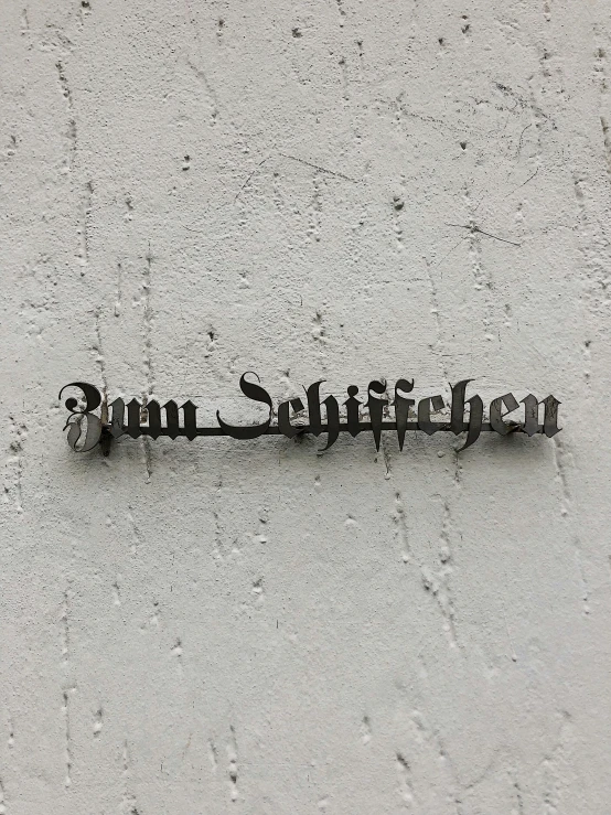 a close up of a sign on the side of a building, inspired by Wilhelm Schnarrenberger, unsplash, ffffound, rich detail, old script, album cover