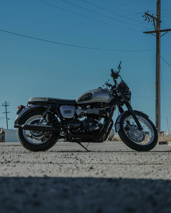 a motorcycle parked on the side of the road, a picture, by Tom Bonson, unsplash contest winner, triumph, steel gray body, 🚿🗝📝, profile image