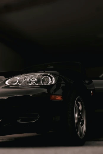 a black sports car in a garage at night