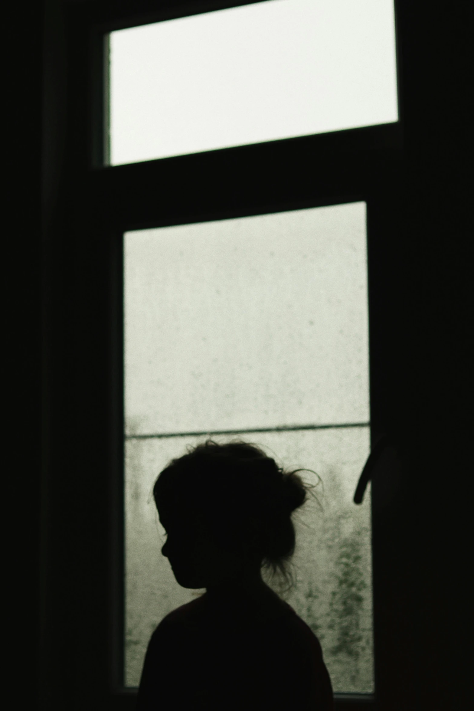 a silhouette of a person standing in front of a window, inspired by Katia Chausheva, little girl, ((portrait)), promo image