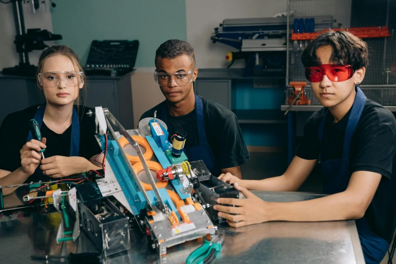 a group of people sitting around a table with a robot, high school, profile image, thumbnail, catapults