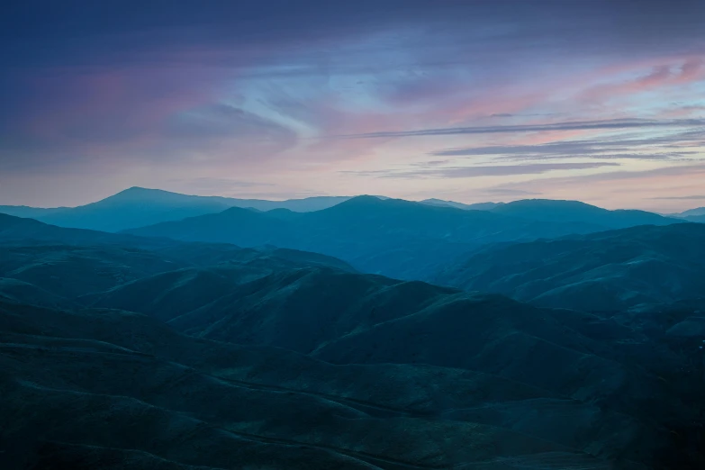 a plane flying over a mountainous region