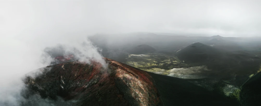 a view of the top of a mountain in the fog