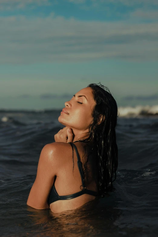 a woman in a bikini in the ocean, an album cover, trending on pexels, relaxed expression, profile image, tan skin, wet look